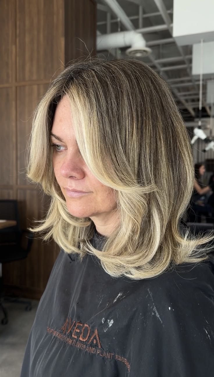 A soft-rooted, bright blonde balayage melt for natural looki
