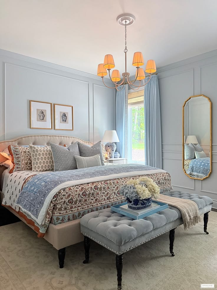 A chic fall bedroom layered with warm colors and gorgeous pa