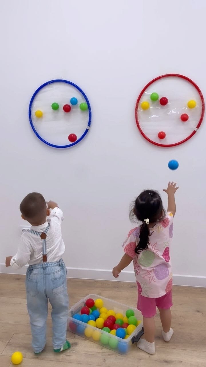 (Ball Toss Game): This bright, whimsical ball toss game is p