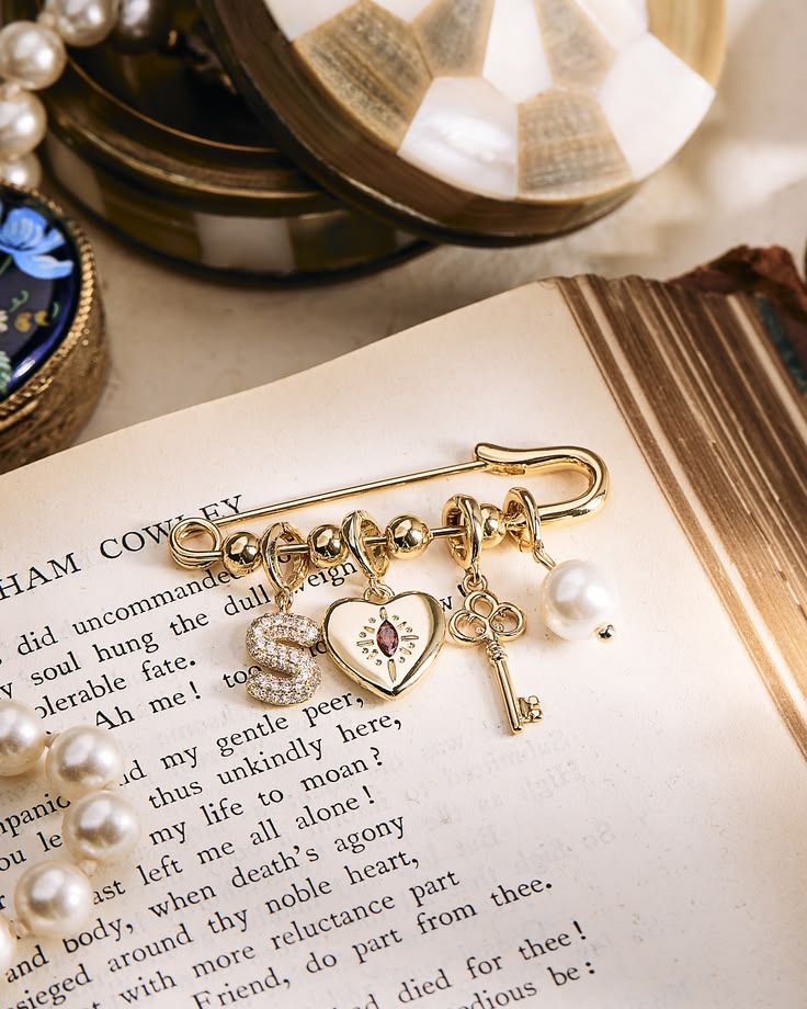 Vintage flair on a custom charm brooch and we’re fully obses