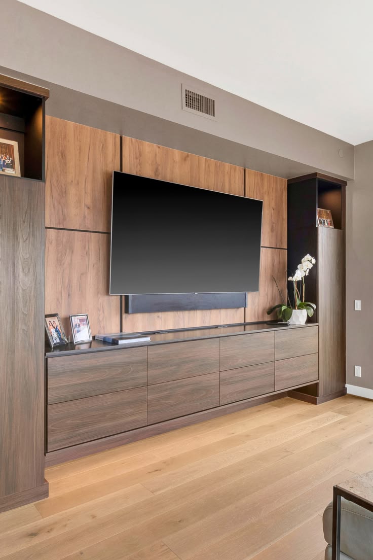 Custom modern entertainment center in warm and dark mixed wo
