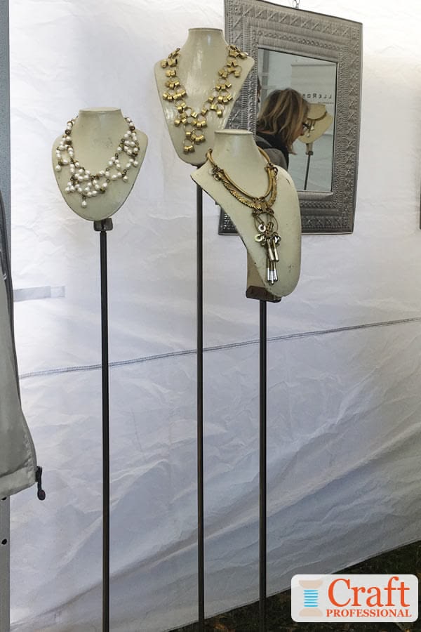 Necklaces on display at an outdoor craft show