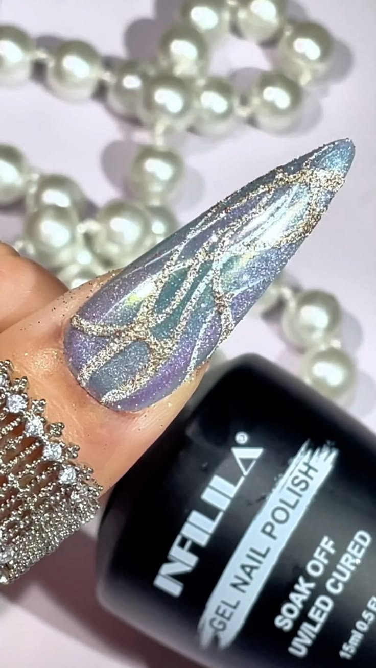 Soft blue nails with delicate white line art and sparkling d