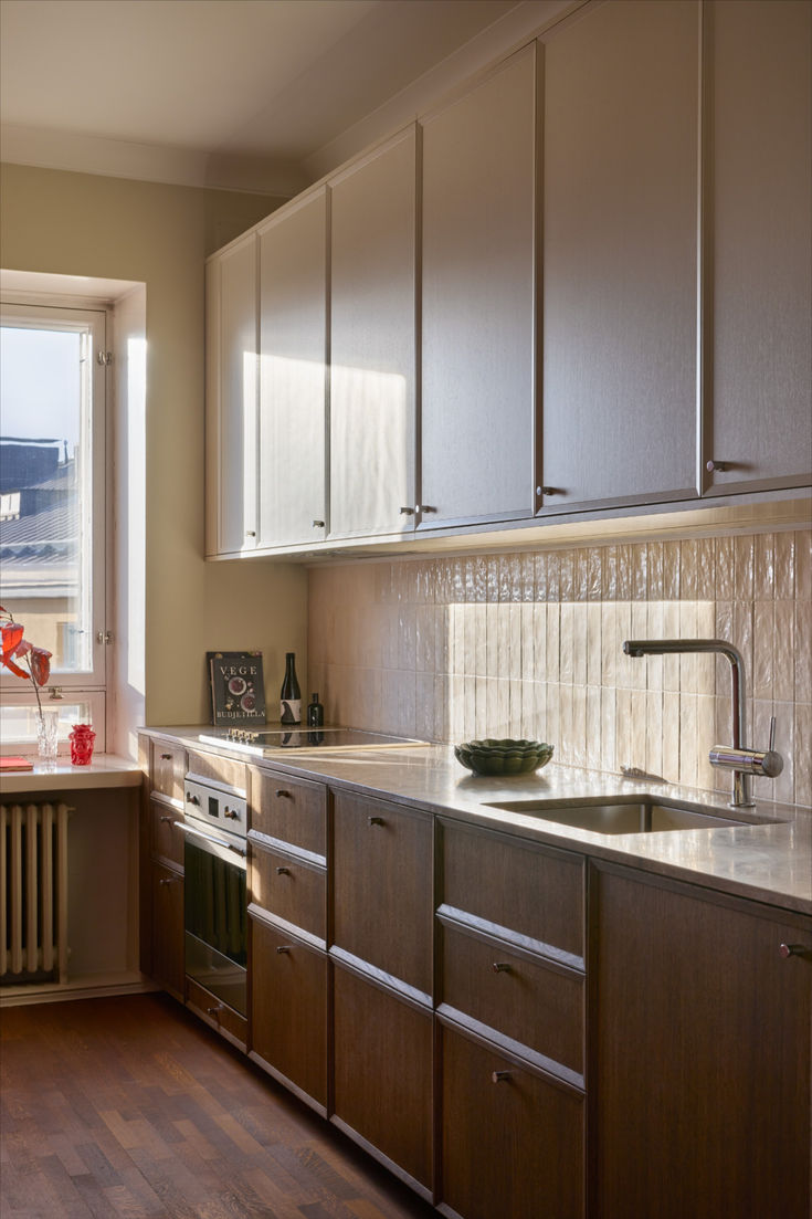 The BRAHE kitchen is defined by layered materials and warm, 