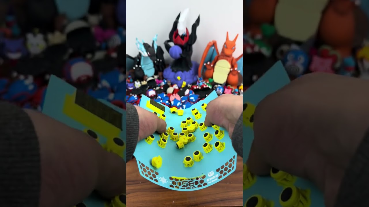 3D printed Poké Ball clickers inspired by Kyogre and Groudon, featuring a pressable button and a sat