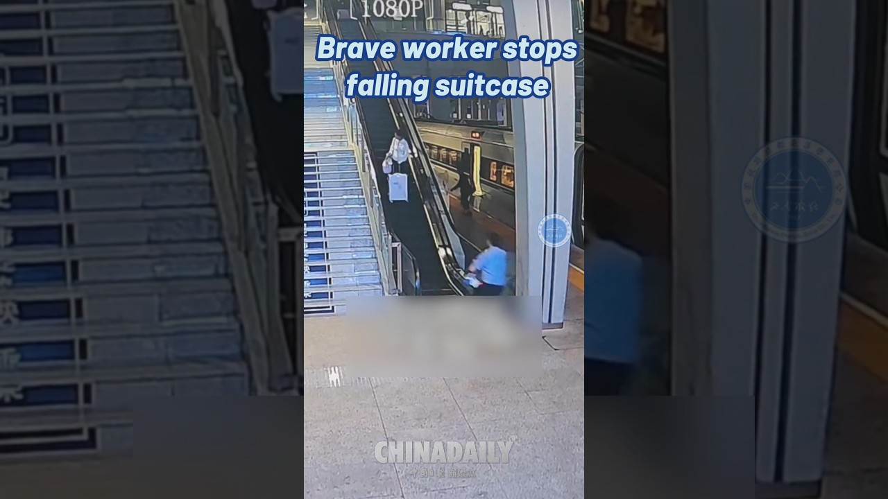 Brave worker stops falling suitcase